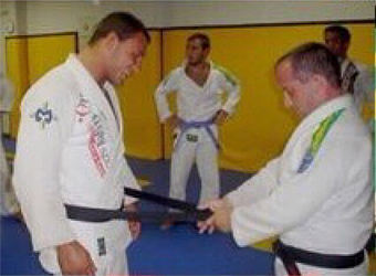 Abreu receiving his black belt on Dec. 2004